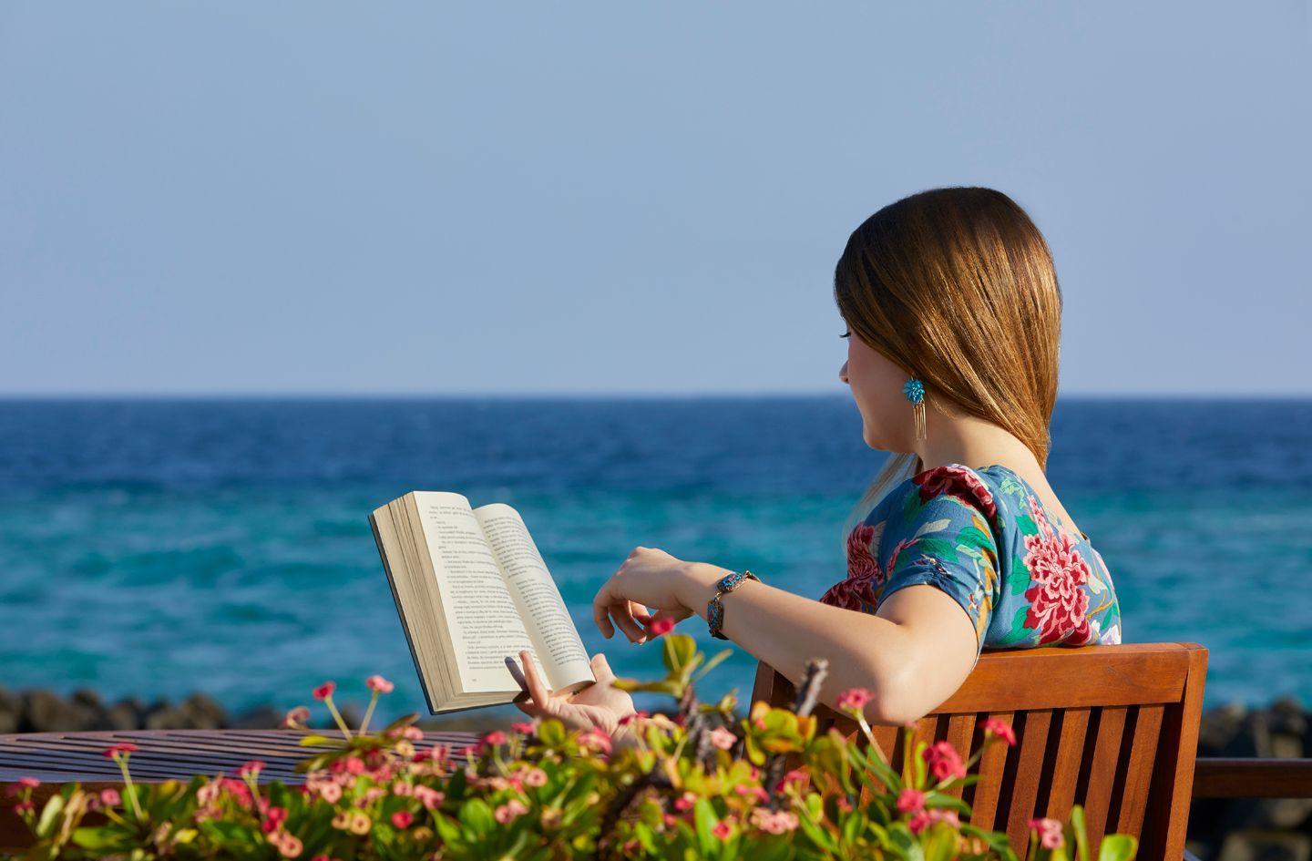 Taj-Coral-Reef-Resort-Spa-Maldives-Resort-Mood-Women-Reading-a-Book.jpg