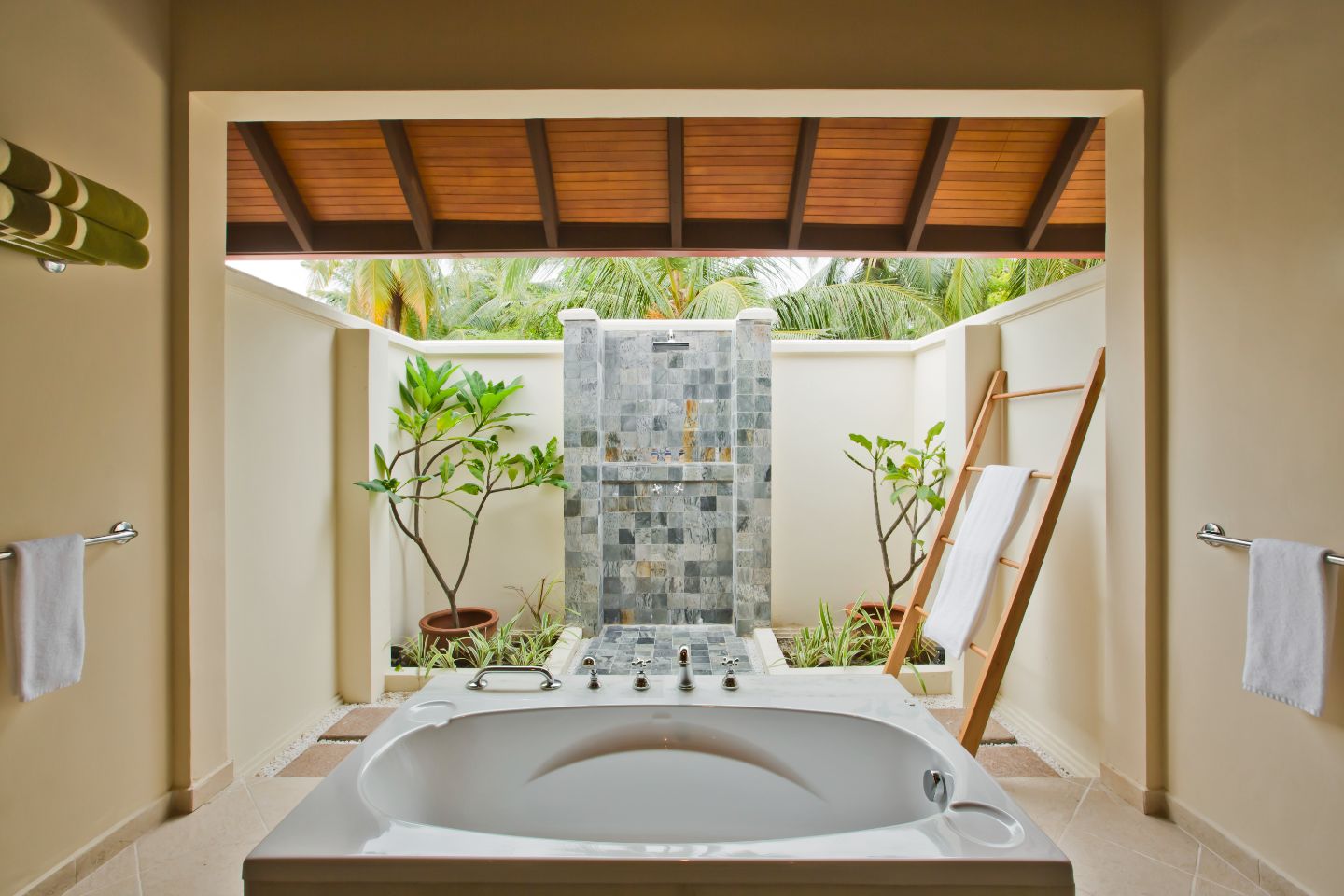 Bathtub, twin vanity, outdoor shower in the superior room at Kurumba Maldives